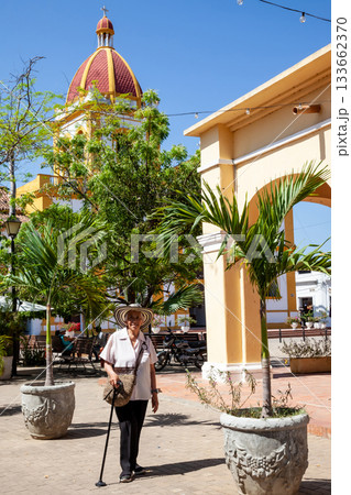 Senior travel. Senior woman at the beautiful heritage town of Mompox wearing the traditional Sombrero vueltiao. Senior travel. Senior woman at the beautiful heritage town of Mompox wearing the traditional Sombrero vueltiao. 133662370
