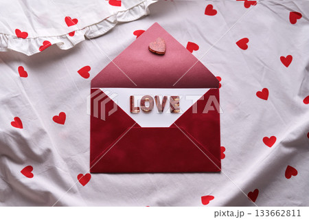 Love letter in red envelope on heart pattern Love letter in red envelope on heart pattern 133662811