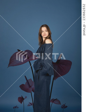 Beautiful woman with dark linen suit studio portrait in Anthurium flowers background 133662832