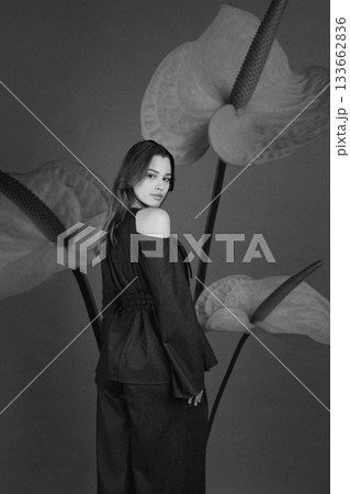 Beautiful woman with dark linen suit studio portrait in Anthurium flowers background Beautiful woman with dark linen suit studio portrait in Anthurium flowers background 133662836