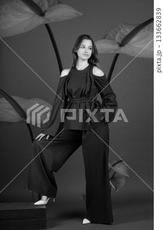 Beautiful woman with dark linen suit studio portrait in Anthurium flowers background 133662839