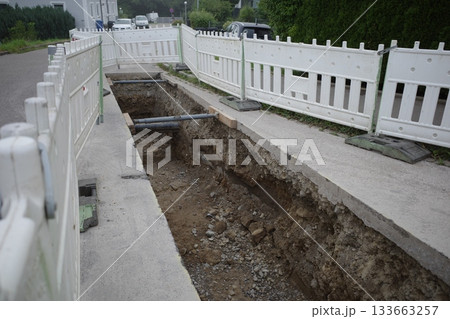 Open Trench with Temporary Fencing for Road Construction 133663257