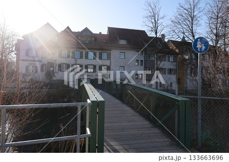 A bridge over a river with a sign on the right side that says "Pedestrians only" A bridge over a river with a sign on the right side that says "Pedestrians only" 133663696