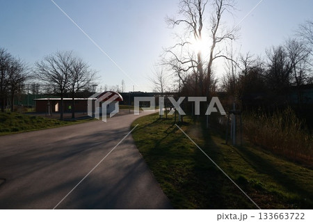 A red building with a mushroom shaped roof is in the foreground of a park A red building with a mushroom shaped roof is in the foreground of a park 133663722