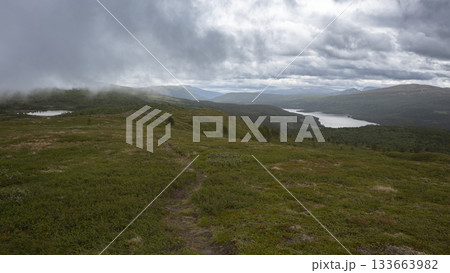 Serene view of Lake Flatningen from Strondsaeterhoe mountain in Vang Municipality, Innlandet County, Norway during cloudy weather 133663982