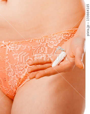 Mentruation time. Girl with hygienic tampon. Mentruation time. Girl with hygienic tampon. 133664185