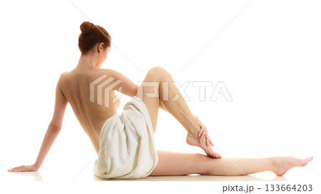 Sitting naked woman in white towel Sitting naked woman in white towel 133664203