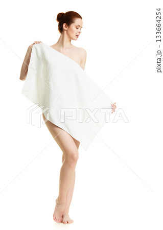 Naked woman hiding behind towel after bath Naked woman hiding behind towel after bath 133664254