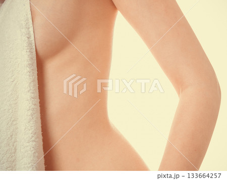 Woman covering breast under towel. Woman covering breast under towel. 133664257