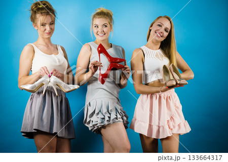 Three women showing high heels shoes Three women showing high heels shoes 133664317