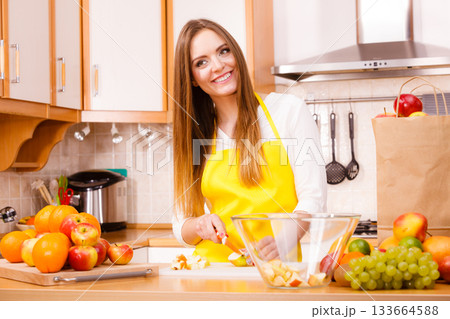 Woman housewife in kitchen cutting apple fruits Woman housewife in kitchen cutting apple fruits 133664588