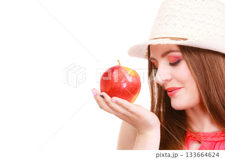 Woman summer hat colorful makeup holds apple fruit Woman summer hat colorful makeup holds apple fruit 133664624