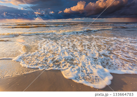 Beatiful sunset with clouds over sea and beach 133664783