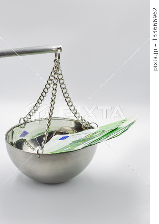 100 Euro banknotes on balance scale symbolizing financial justice concept. 100 Euro banknotes on balance scale symbolizing financial justice concept. 133666962