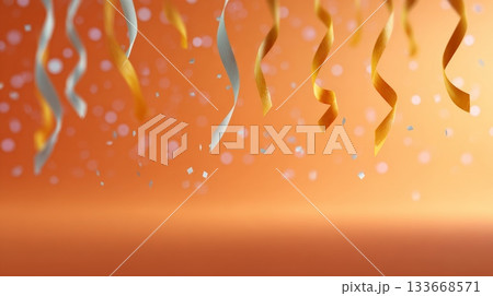 Golden and silver party streamers and falling confetti creating a festive background with soft bokeh lights and copy space, symbolizing celebration, holidays, and joy 133668571