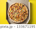 Top View of Fresh Pizza in Open Takeout Box on Yellow Background 133671195