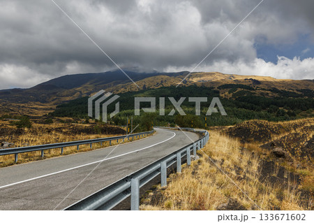 Mountain road on Mount Etna volcano in Sicily, Italy Mountain road on Mount Etna volcano in Sicily, Italy 133671602