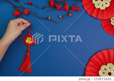 Hand Holding Traditional Chinese New Year Decoration 133671828