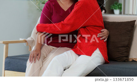 Affectionate Moment Between Mother and Daughter on Sofa 133671850