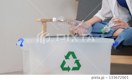 Recycling. Individual sorting plastic bottles into recycling bin at home. Recycling. Individual sorting plastic bottles into recycling bin at home. 133672001