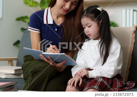 Nurturing Education: Mother and Daughter Engaged in Learning 133672073