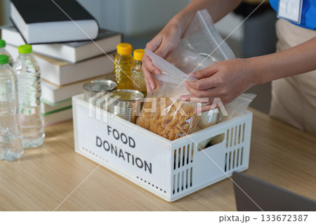 Food Donation. Volunteers organizing food items for community support. 133672387