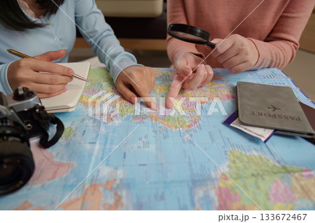 Travel Planning. Friends examining a map for their next trip. Travel Planning. Friends examining a map for their next trip. 133672467