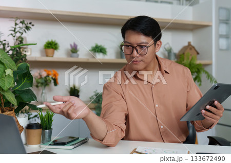Digital Strategy. Professional discussing financial insights using tablet in modern office. 133672490