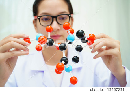 Scientist holding molecular model for chemical technology. Scientist holding molecular model for chemical technology. 133672514