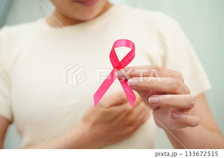 Asian woman with pink ribbon for October world breast cancer day. 133672515