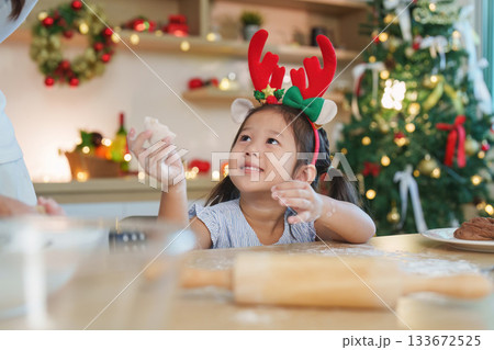 SSTK Christmas: Child Smiling While Baking Cookies with Parent SSTK Christmas: Child Smiling While Baking Cookies with Parent 133672525
