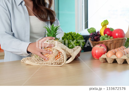 Sustainability. Eco-friendly shopping with reusable bag filled with fresh produce. 133672576