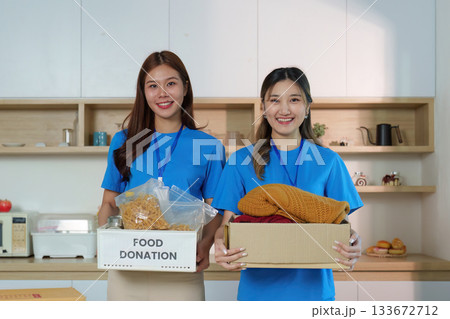 Women Holding Donation Boxes: Community Spirit and Generosity Women Holding Donation Boxes: Community Spirit and Generosity 133672712