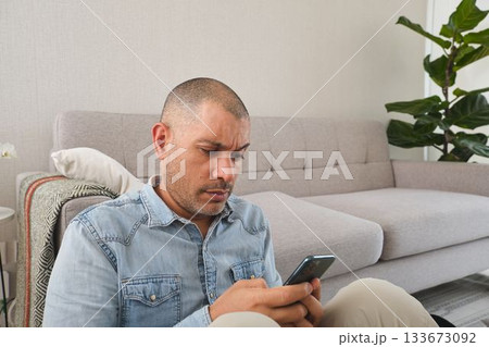 Man concentrating on smartphone while browsing online 133673092