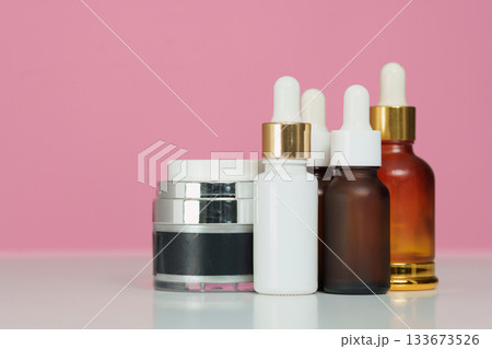 Beauty Products. Collection of skincare bottles and jars on pink background. Beauty Products. Collection of skincare bottles and jars on pink background. 133673526