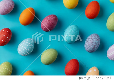 Colorful pattern composition made of various colored Easter eggs on light blue background. Minimal Easter concept. Creative festive spring holiday backdrop. Easter aesthetic. Flat lay, top of view. 133674061