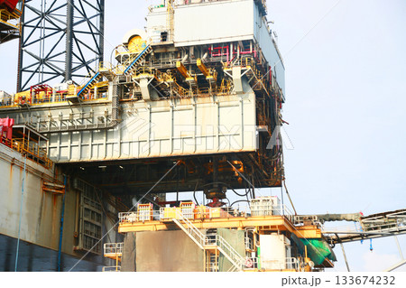 Oil and rig in offshore with sunset and sunrise time. The construction platform for production oil and gas in power and energy industry. Oil and rig in offshore with sunset and sunrise time. The construction platform for production oil and gas in power and energy industry. 133674232