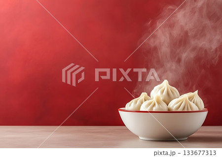 Steaming Dumplings Served in a Bowl Against Bright Red Background for Culinary Use 133677313