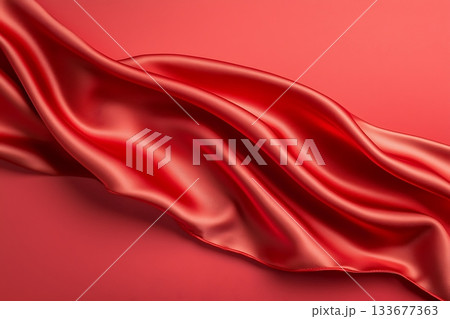 Flowing Red Silk Fabric on a Smooth Surface Creating a Luxurious and Elegant Appearance 133677363