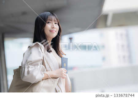 海外旅行に向けてパスポートを持つ若い女性の笑顔と出発シーン 133678744