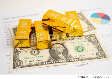 Gold bars on US dollar banknote money, finance trading investment business currency concept. Gold bars on US dollar banknote money, finance trading investment business currency concept. 133680295