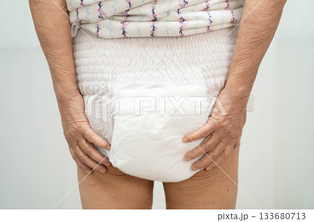 Asian senior woman patient wearing adult incontinence diaper pad in hospital. Asian senior woman patient wearing adult incontinence diaper pad in hospital. 133680713