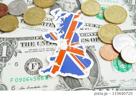 United Kingdom flag on coin and banknote money, finance trading investment business currency concept. United Kingdom flag on coin and banknote money, finance trading investment business currency concept. 133680720