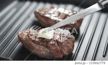 preparing steak filet mignon with butter preparing steak filet mignon with butter 133682779
