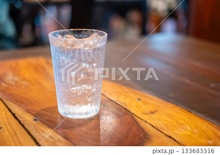 A glass of iced water on the table 133683316