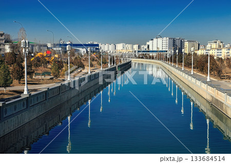 ASHGABAT, TURKMENISTAN. Modern architecture of Ashgabat. View of the water channel. ASHGABAT, TURKMENISTAN. Modern architecture of Ashgabat. View of the water channel. 133684514