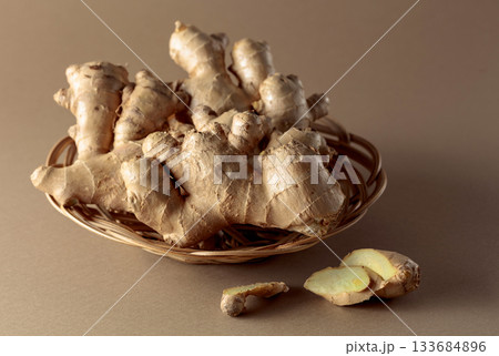 Ginger root on a beige background. Ginger root on a beige background. 133684896