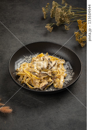 Creamy tagliatelle pasta with mushrooms 133684944