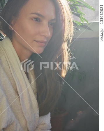 Woman in Robe Bathed in Golden Sunlight, Morning Serenity 133685021