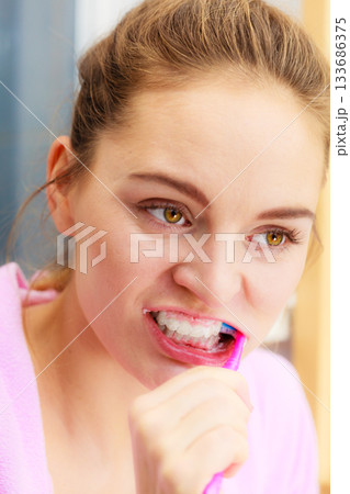 Woman brushing cleaning teeth in bathroom 133686375